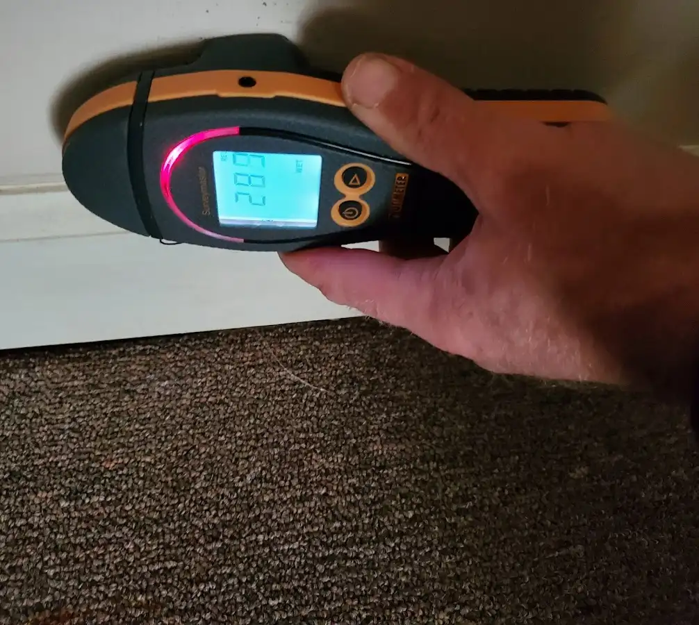 Moisture detection at baseboard during Storm Damage Restoration in Largo